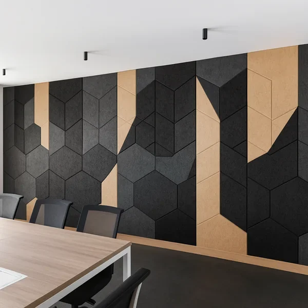 Black and grey hexagon acoustic panels with timber strips on a meeting room wall, lit by ceiling-mounted spotlights