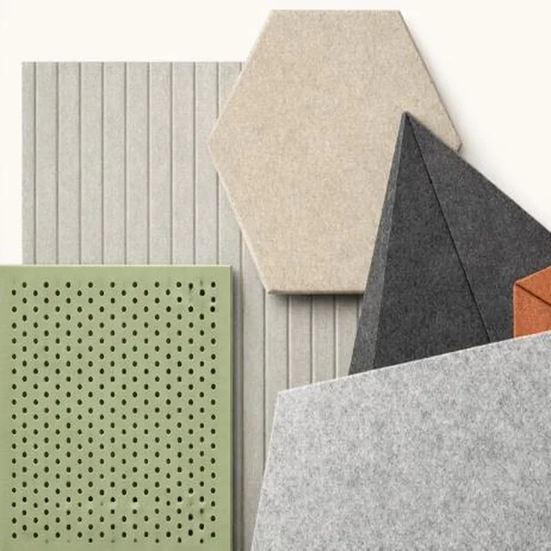 Acoustic panel samples including a beige hexagon, a charcoal triangle, a green perforated panel and a grey ribbed panel