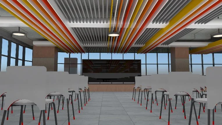 Large room with rows of white tables and stools facing a wall screen, under a ceiling of red, yellow and green acoustic baffles