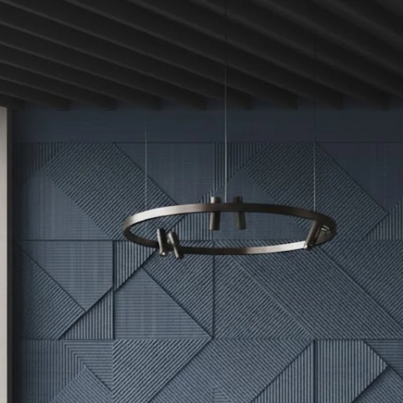 Slate-blue grooved geometric acoustic wall panels in a meeting room with a ring pendant light